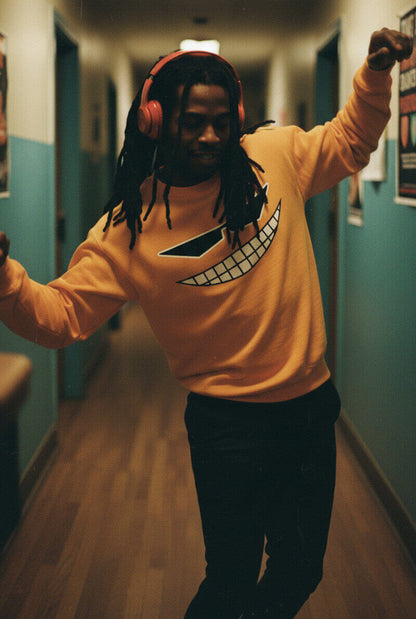 Man with dreadlocks and headphones dancing down a hallway, wearing the yellow Sovereign Emblem "Sovereign Grin" sweatshirt.