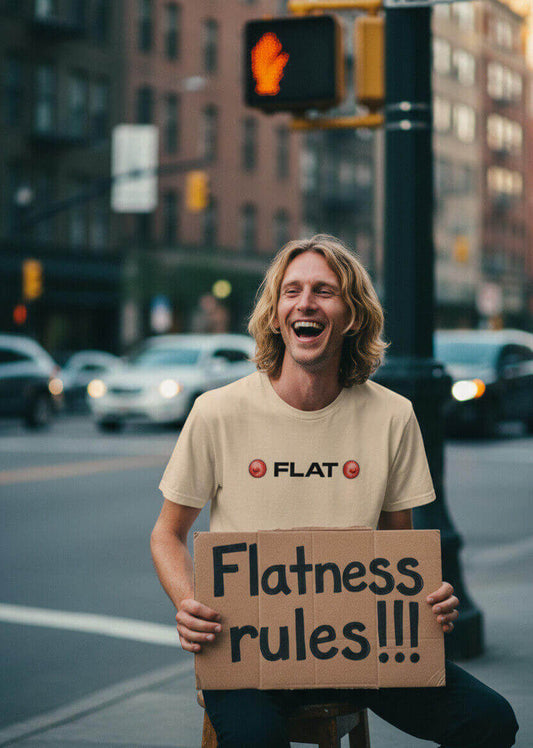 Man laughing while holding a satirical "Flatness rules!!!" protest sign and wearing the beige Sovereign Emblem 'FLAT' t-shirt.