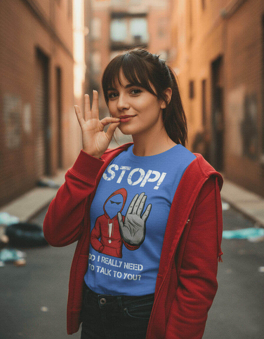 Female model with a smirk making a "zip your lips" gesture, wearing the Sovereign Emblem sarcastic t-shirt in royal blue Heather.